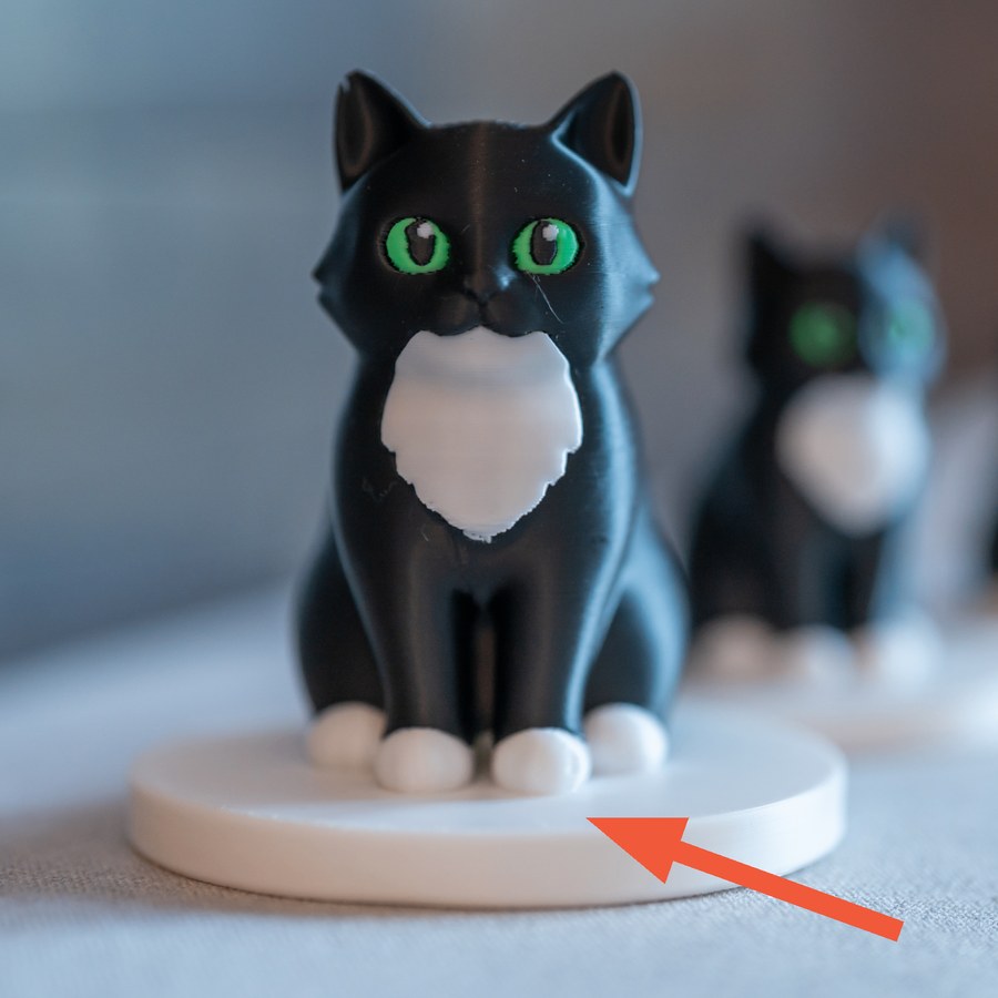 Figurine on a round base, with an arrow pointing to the base