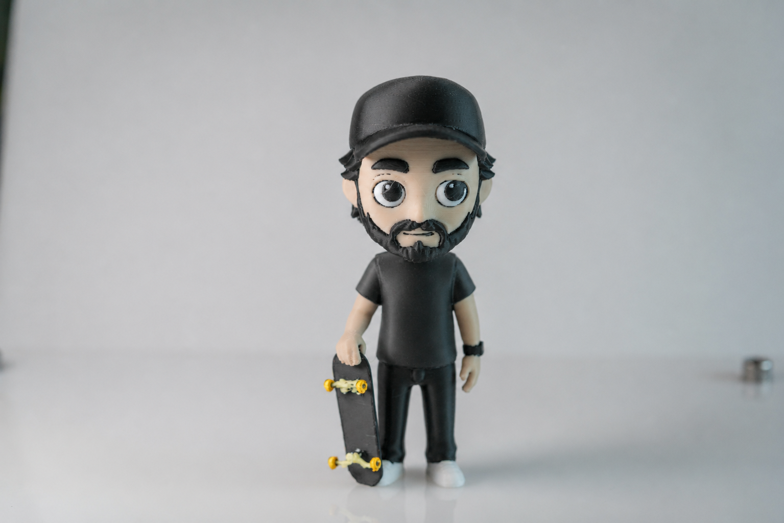 The finished 3D-printed birthday MiniMe figurine holding a skateboard